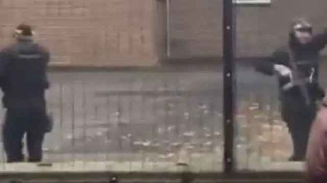 Screengrab from a verified video showing armed police outside the synagogue in Manchester