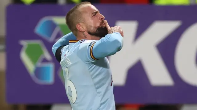 Alex Pattison celebrates by raising his finger to his lips