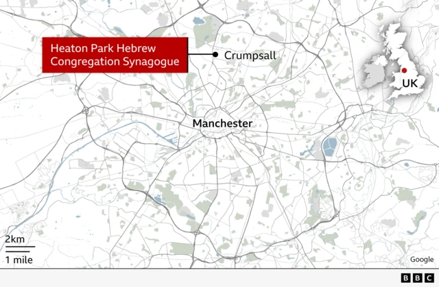 The attack took place at Heaton Park Hebrew Congregation Synagogue in Crampsall, an outer suburb of Manchester. The area has been cordoned off and the public are being advised to stay away while emergency services deal with the major incident.        Alt text: A map that shows the location of Heaton Park Hebrew Congregation Synagogue in Crampsall. A locator map shows where Manchester is in the UK and a red label highlights where the synagogue is.