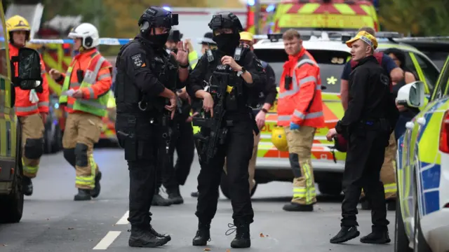 Emergency workers stand together at the scene