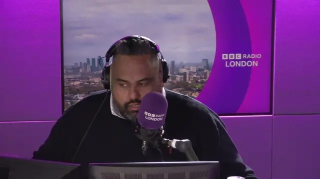 Aaron Paul speaking into a purple BBC London mic
