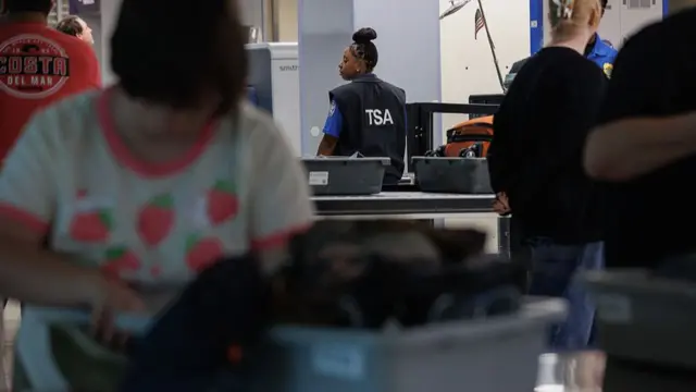 TSA agents inspect security goods at an airport