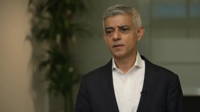 Sadiq Khan in a black jacket and white shirt.