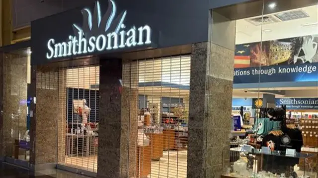 Smithsonian shop front in an airport with the security grill in front of the doors