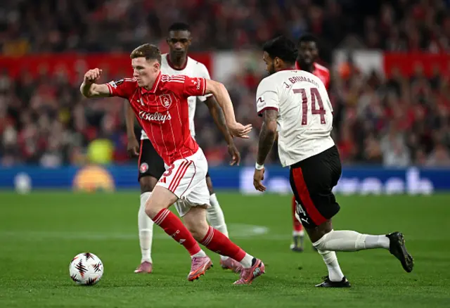 Elliot Anderson of Nottingham Forest is put under pressure by Junior Brumado