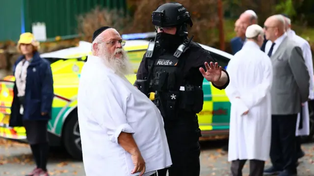 Police speak to man outside synagogue