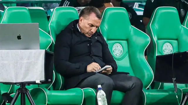 Brendan Rodgers makes notes on the Celtic bench