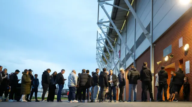 Fans queue to enter the New York Stadium