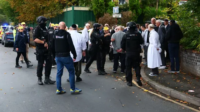People gather outside synagogue