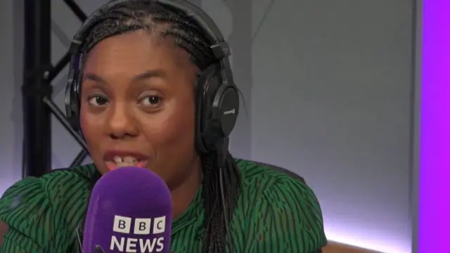 Kemi Badenoch speaking into microphone that says BBC News.
