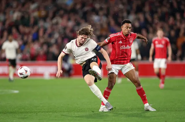 Mads Bech Sorensen of FC Midtjylland is challenged by Dan Ndoye