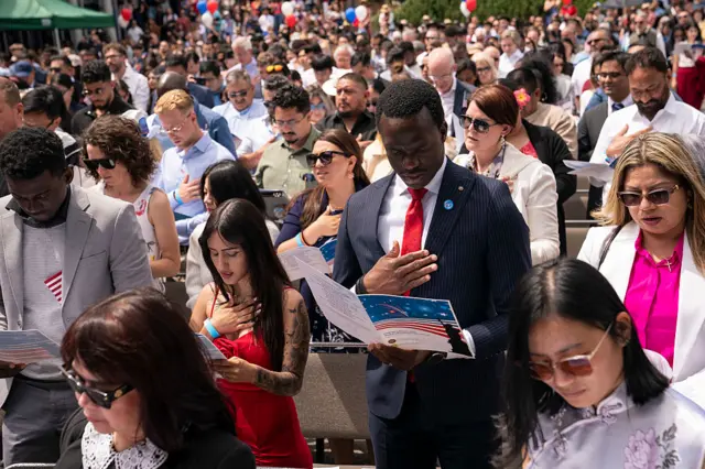 Participants recite the Pledge of Allegiance during a naturalization ceremony for new US citizens at Seattle Center.