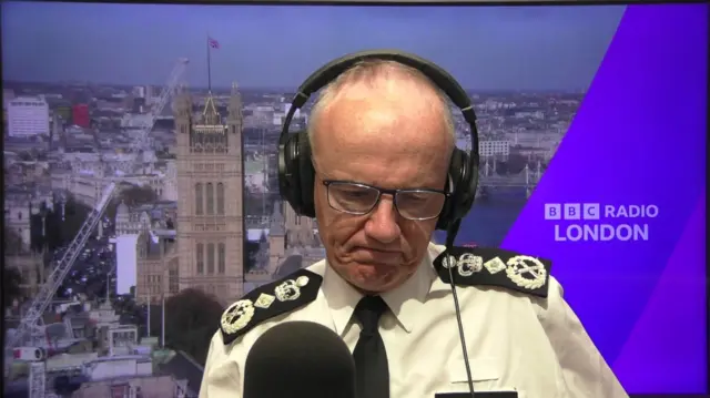 Sir Mark Rowley in uniform, speaking to BBC London through Radio set up