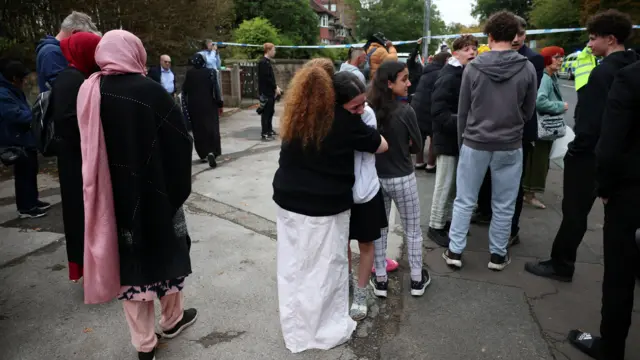 People hug outside synagogue