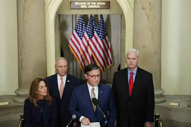 four republican congress members standing at a podium