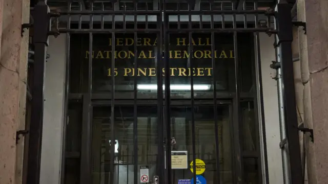 A gate is locked at the public entrance to the Federal Hall National Memorial during the first day of a partial U.S. government shutdown in New York City, US