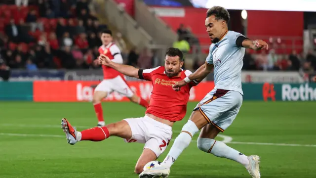 Rotherham's Joe Rafferty slides in to tackle Bradford's Tyreik Wright