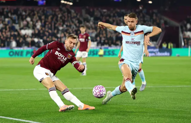 West Ham United's Jarrod Bowen in action with Brentford's Kristoffer Ajer