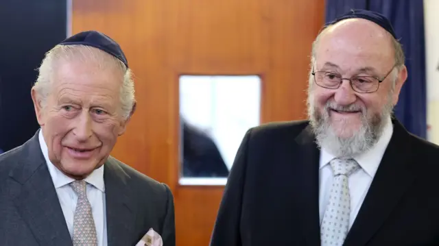 King Charles wears a kippah as he stands with Chief Rabbi Sir Ephraim Mirvis
