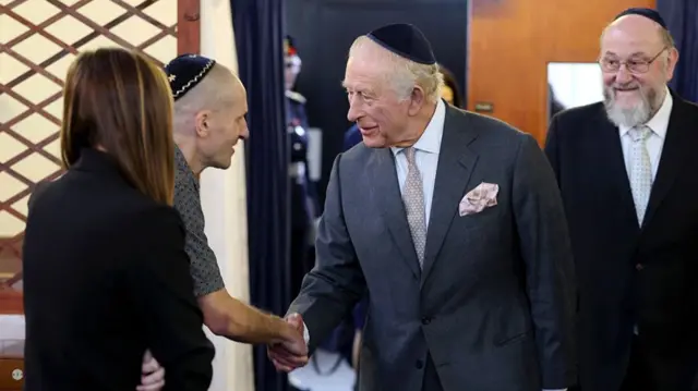 King Charles shakes hands with members of the Jewish community