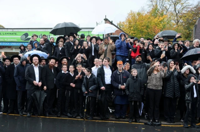 Well-wishers turning out with umbrellas to see King Charles