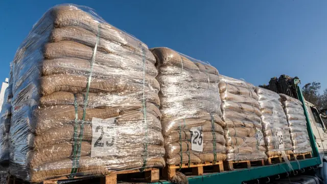 A close-up of bags of aid waiting on lorries
