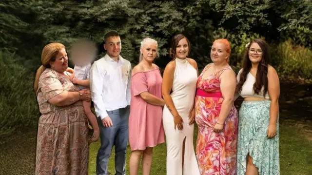 A photo of five women and one man photoshopped onto a woodland background. The women are all wearing summer dresses and the man is in jeans and a white shirt