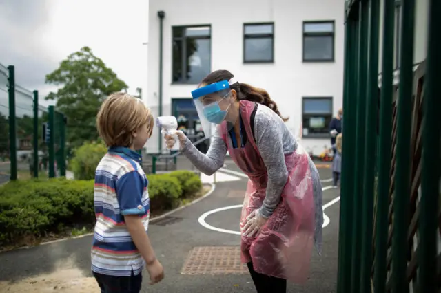 A child's temperature is taken at a school in London