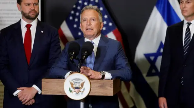 Steve Witkoff in a blue suit at a podium