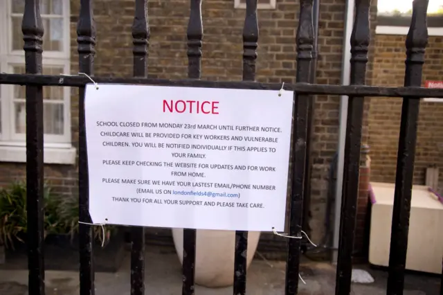A school closure sign is seen in front of a daycare