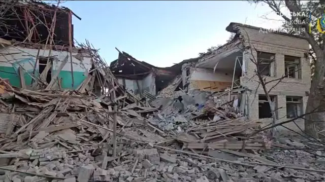A partially collapsed building following a reported Russian drone attack on Kherson. Rubble and debris is strewn around the ground