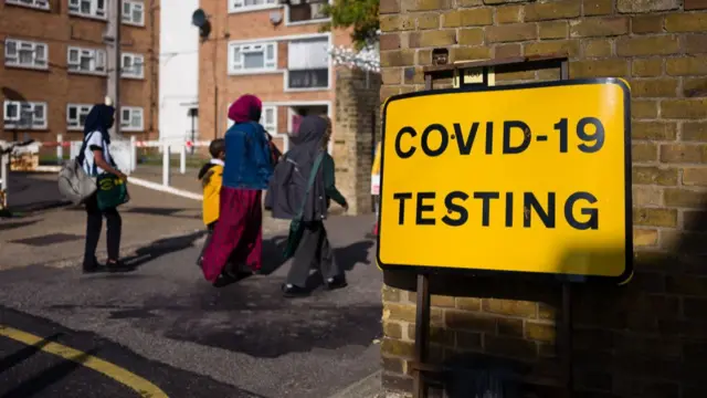 A family in a housing estate are walking into a Covid-19 testing centre during the lockdown