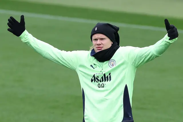 Erling Haaland waves his arms in Manchester City training