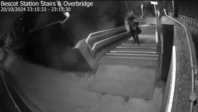 A black and white picture showing dark figure on steps