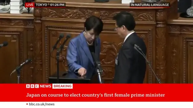 Takaichi in blue blazer casting her vote