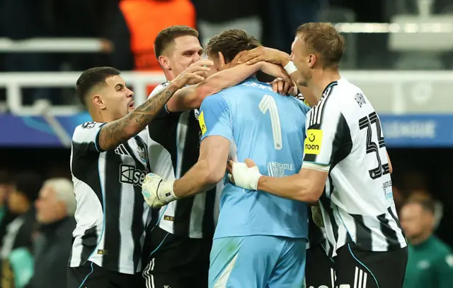 Newcastle players celebrate with Nick Pope
