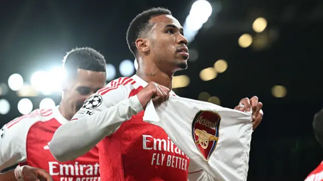 Gabriel celebrates with a corner flag after scoring