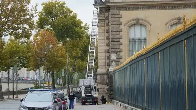 A ladder is seen outside the Louvre, where thieves broke in