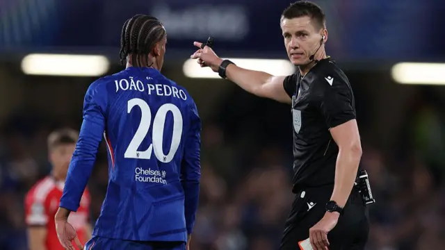 João Pedro of Chelsea reacts after being shown a red card by the Referee, Daniel Siebert