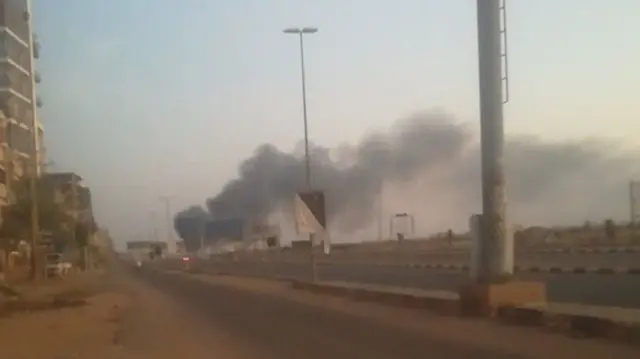 Smoke rising from down a highway in the distance