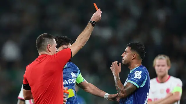Emerson Palmieri is shown a red card for Marseille