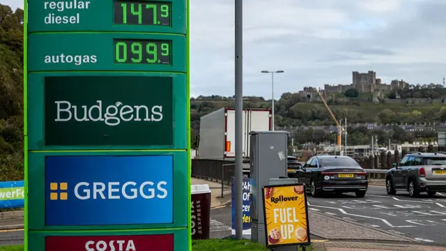 Petrol prices are seen at a gas station