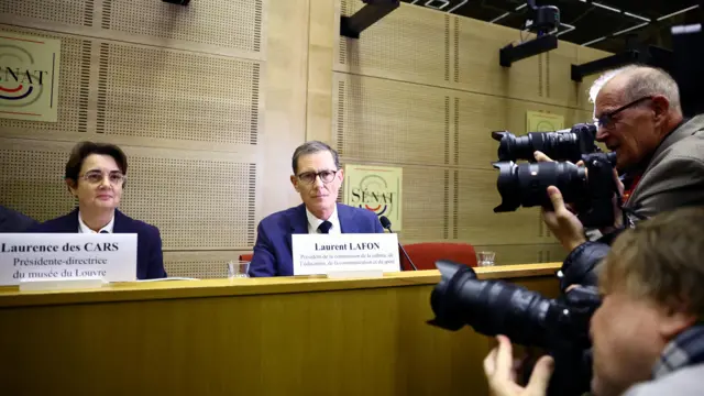 Laurence des Cars, president and director of the Louvre Museum, sits next to French Senator Laurent Lafon