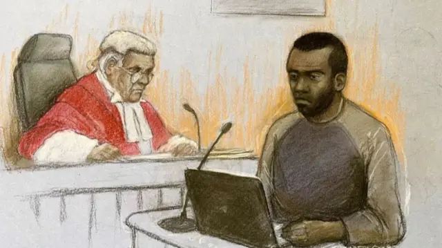A drawing of a man with dark hair and a grey top with a microphone and a laptop in front of him and a judge in a white wig and red gown in the background