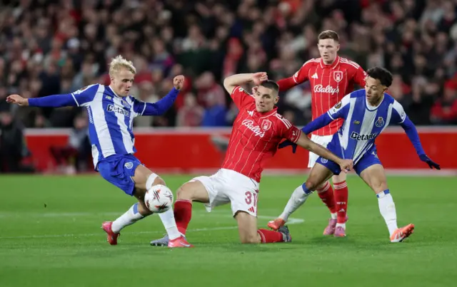 Nottingham Forest's Nikola Milenkovic in action with FC Porto's Pepe and FC Porto's Victor Froholdt
