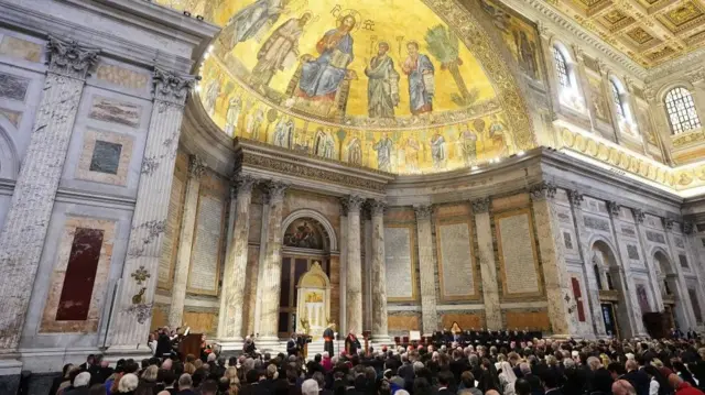Papal Basilica and Abbey of St Paul's Outside the Walls. Image shows the inside of the basilica where congregants have gathered for the service.