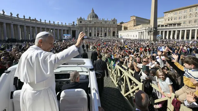 Pope waves at crowds from vehicle
