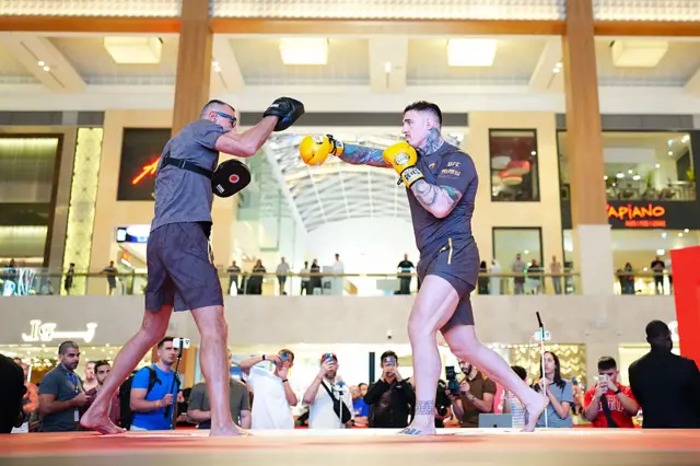 Tom Aspinall hits pads in front of fans