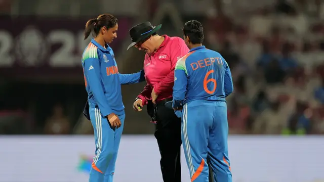 Harmanpreet Kaur and Deepti Sharma of India check on Umpire Sue Redfern