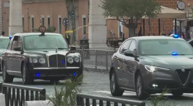 The King's motorcade approaches the Vatican on an overcast day in Rome